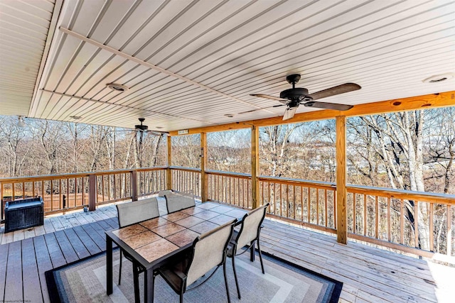 deck featuring outdoor dining space and ceiling fan