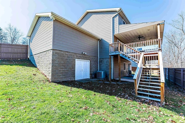 back of house with a lawn, a ceiling fan, stairway, fence, and cooling unit