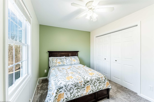 bedroom with a ceiling fan, carpet, a closet, and baseboards