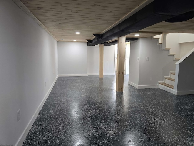 finished basement with stairs, recessed lighting, wood ceiling, and baseboards