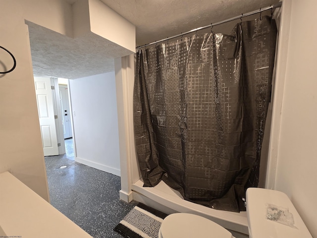 full bathroom featuring a textured ceiling, a shower stall, visible vents, and baseboards