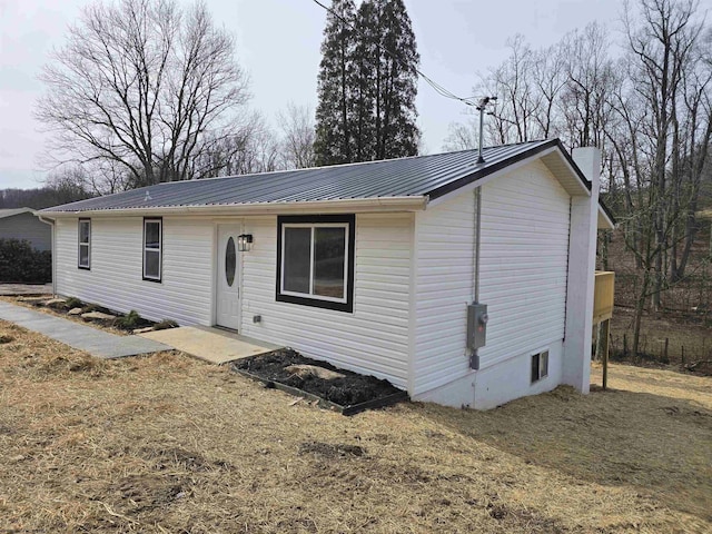 ranch-style home with metal roof