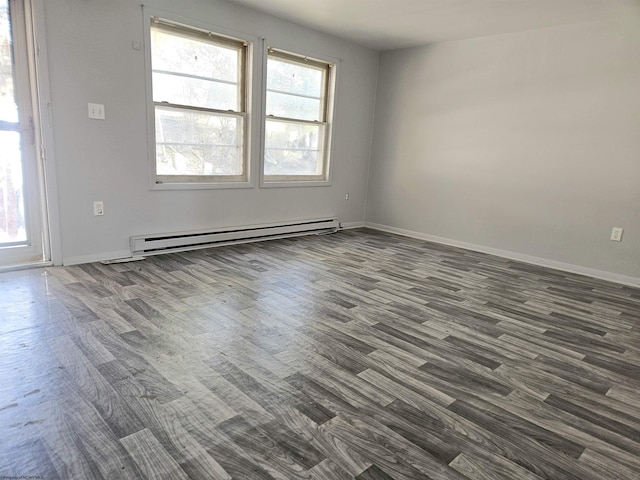 unfurnished room with baseboard heating, dark wood finished floors, and baseboards