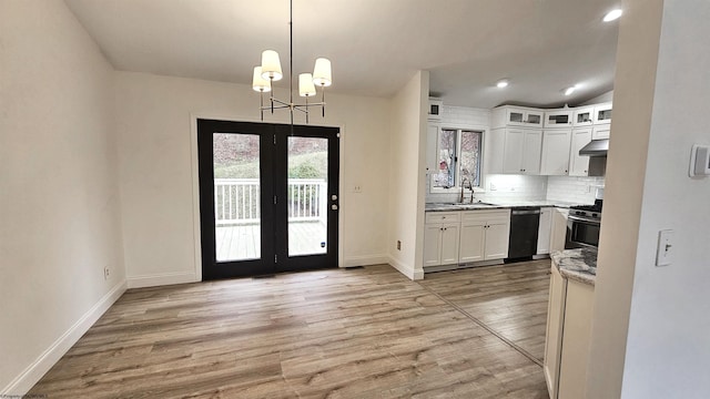 kitchen featuring french doors, stainless steel gas stove, a sink, and white cabinets