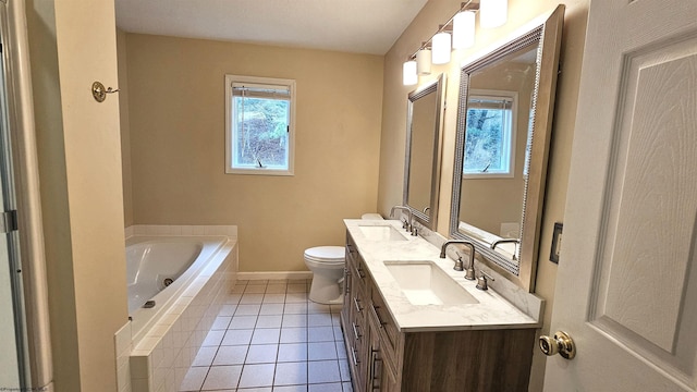 bathroom with double vanity, a garden tub, a sink, and tile patterned floors