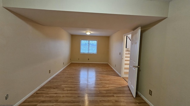 spare room with wood finished floors and baseboards