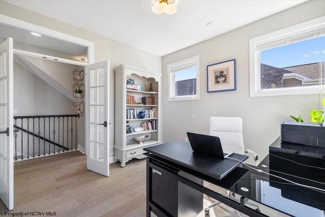 office area with light wood-style flooring and french doors