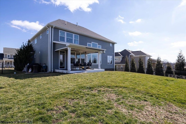 back of property featuring a yard, a patio area, and fence