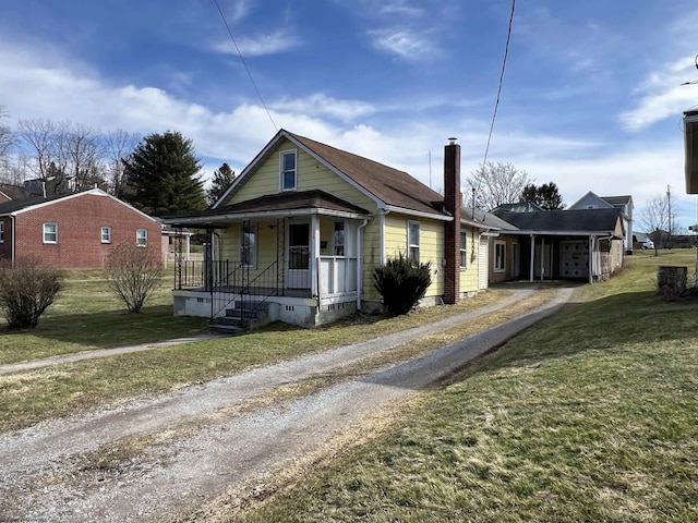 bungalow-style home with driveway, a porch, crawl space, and a front lawn