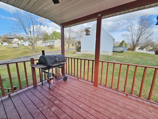 deck with a lawn and area for grilling