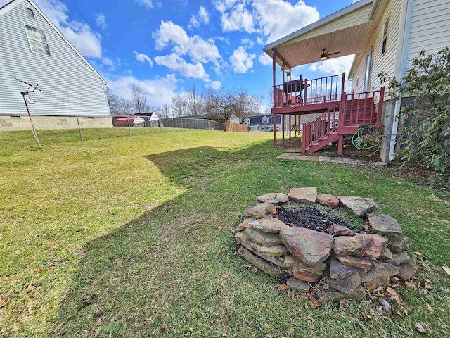 view of yard featuring a deck, stairway, and a fenced backyard