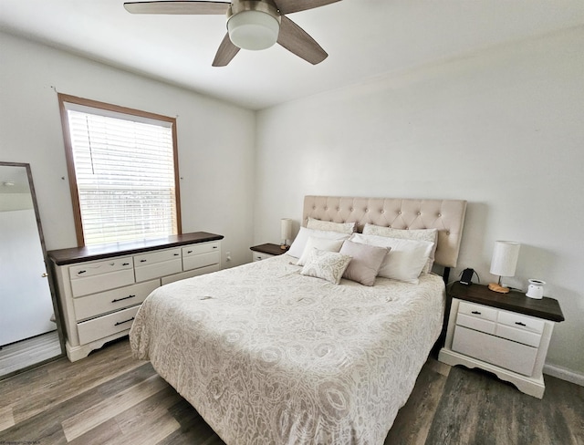 bedroom with ceiling fan and dark wood-type flooring