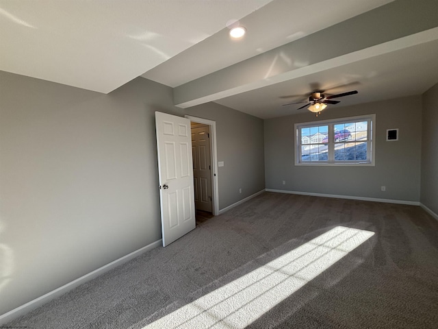 carpeted spare room with ceiling fan and baseboards