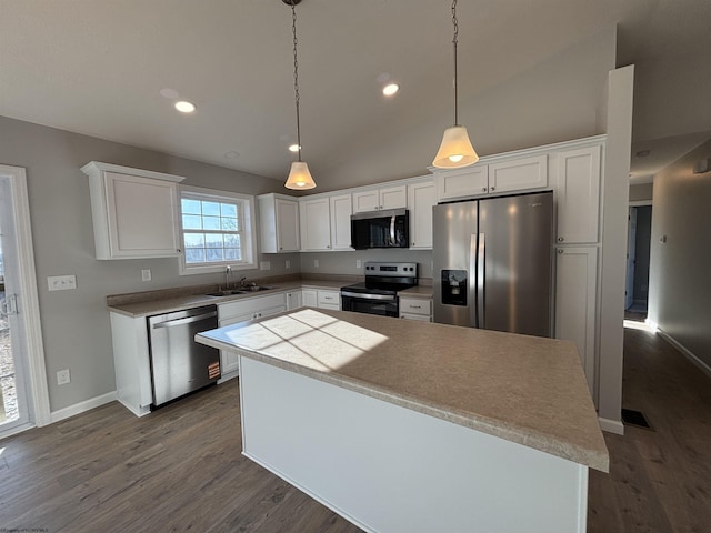 kitchen featuring appliances with stainless steel finishes, dark wood finished floors, white cabinets, and a sink