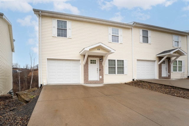 townhome / multi-family property featuring a garage and concrete driveway