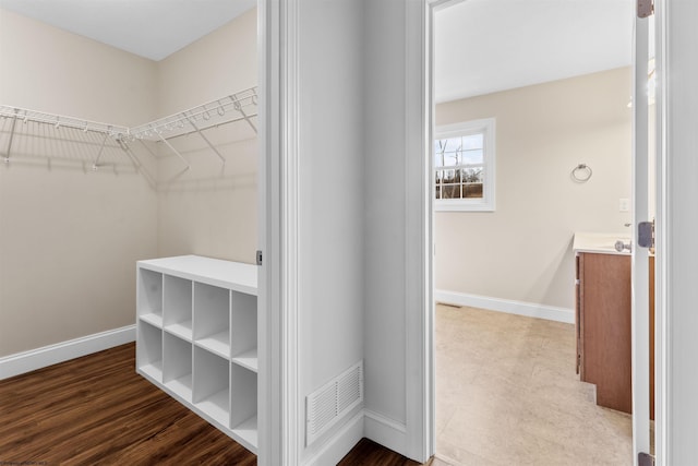 walk in closet with wood finished floors and visible vents