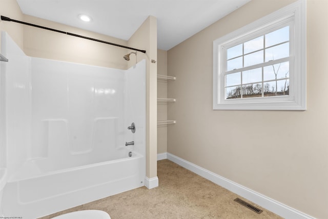 bathroom featuring shower / bath combination, visible vents, and baseboards