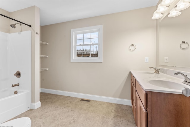 full bath with  shower combination, double vanity, a sink, and baseboards