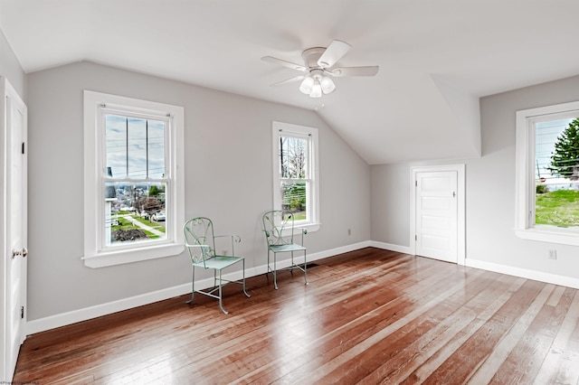 additional living space featuring lofted ceiling, hardwood / wood-style flooring, and baseboards