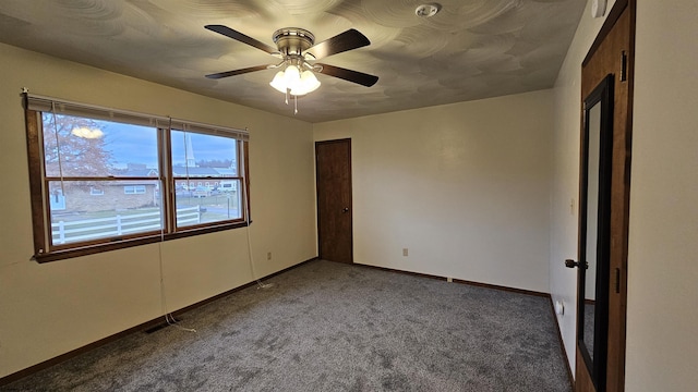 unfurnished bedroom featuring ceiling fan, carpet flooring, visible vents, and baseboards