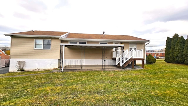 back of property with a patio area and a lawn