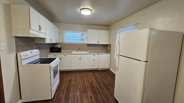 kitchen featuring tasteful backsplash, white cabinets, a sink, white appliances, and under cabinet range hood