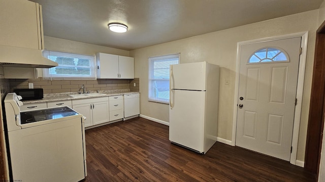 kitchen with white cabinets, white appliances, dark wood finished floors, and a sink