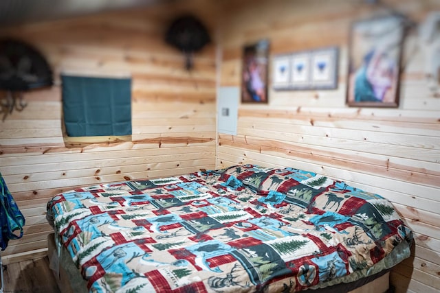 bedroom featuring wood walls