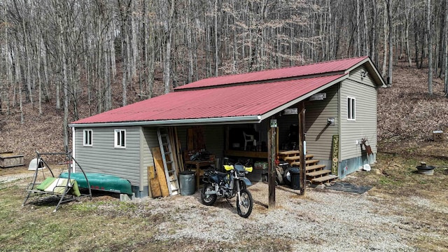 view of outdoor structure featuring a wooded view