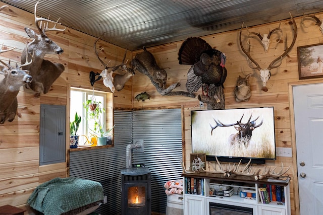 interior space with wood walls and electric panel