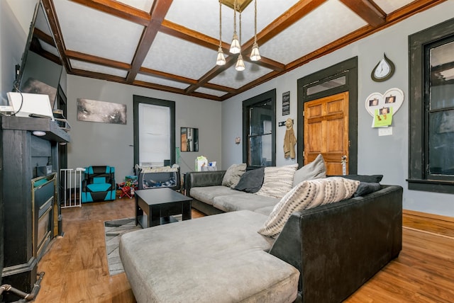 living room featuring coffered ceiling, wood finished floors, and beam ceiling