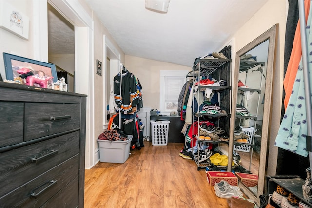 walk in closet with vaulted ceiling and wood finished floors