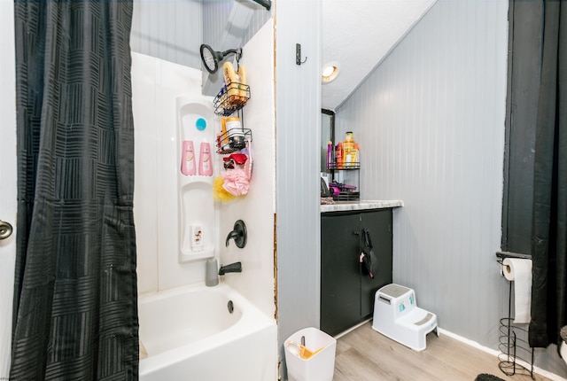 bathroom with vanity, wood finished floors, and shower / tub combo with curtain