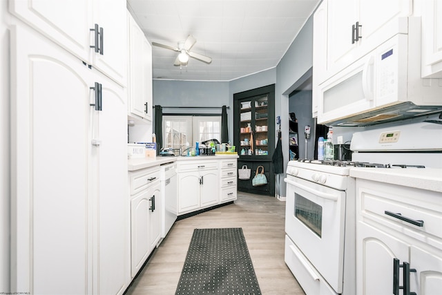 kitchen featuring white cabinets, white appliances, light wood-style flooring, and light countertops