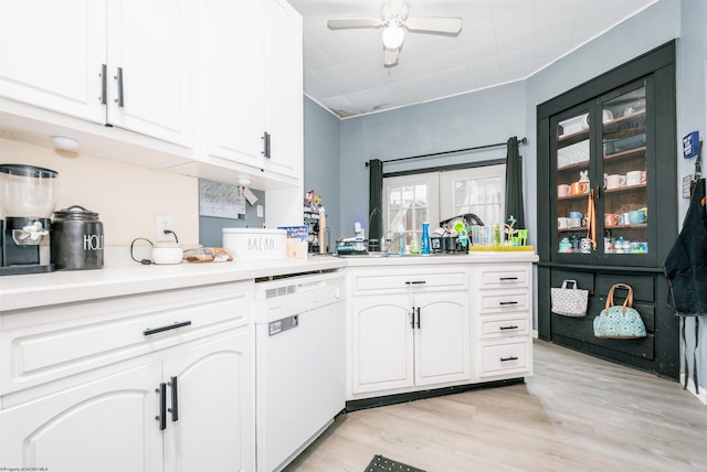 kitchen featuring ceiling fan, white dishwasher, light wood-style flooring, white cabinetry, and light countertops