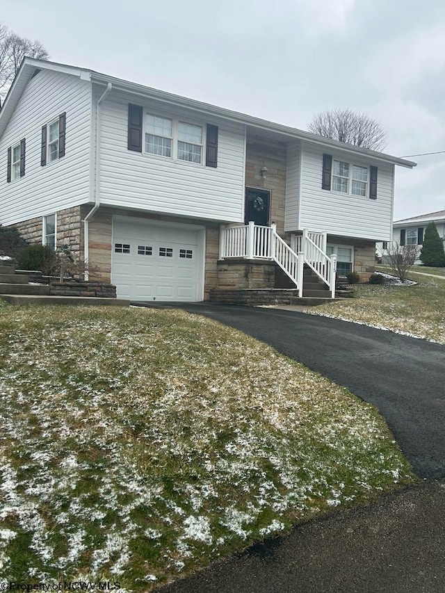 split foyer home with an attached garage and aphalt driveway