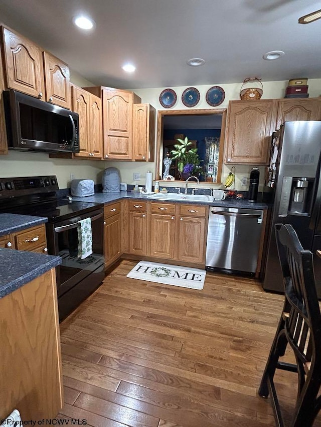 kitchen with recessed lighting, electric range, stainless steel dishwasher, fridge with ice dispenser, and dark wood-style floors