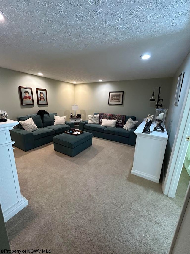 carpeted living area with recessed lighting and a textured ceiling