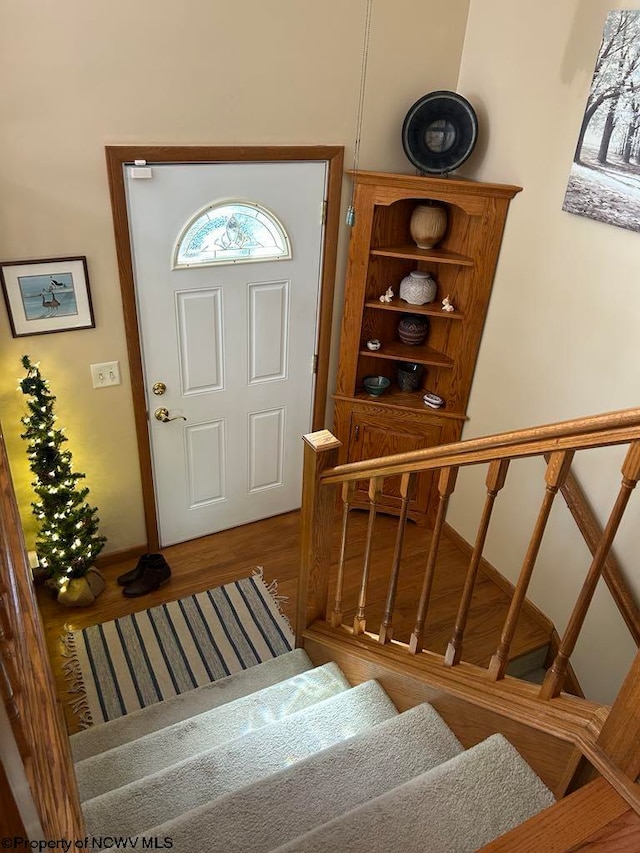 foyer featuring stairway and wood finished floors