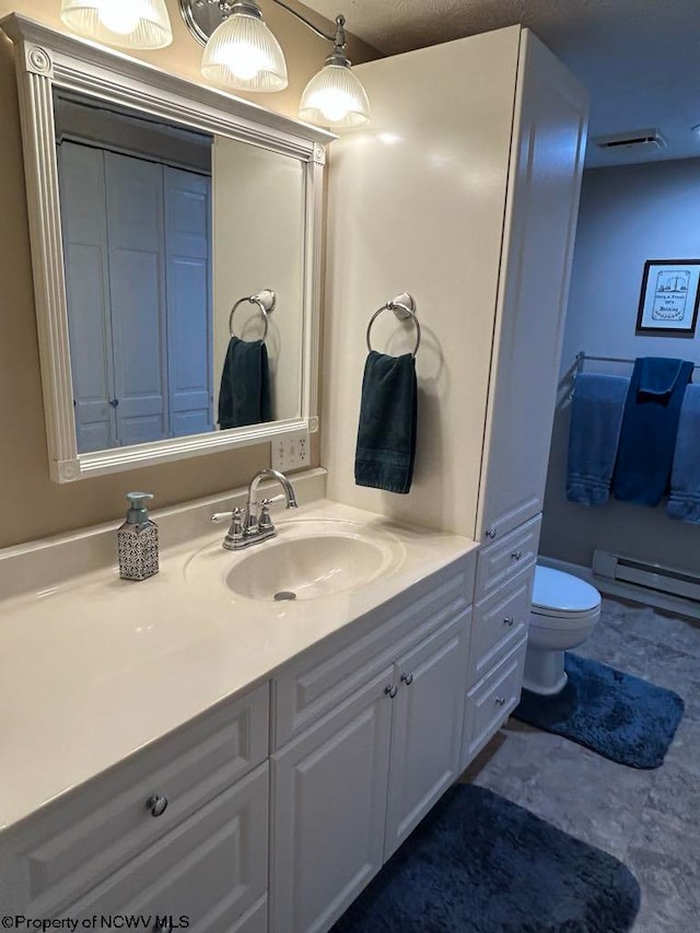 bathroom with toilet, a baseboard radiator, visible vents, and vanity