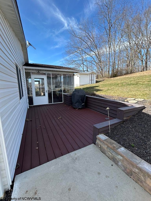 wooden terrace with a grill and a yard