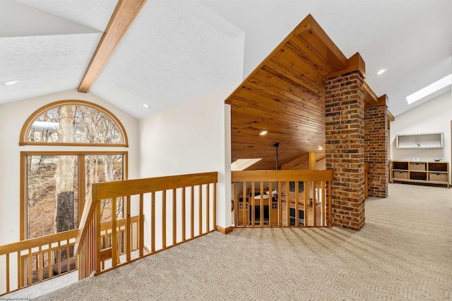 hallway featuring carpet floors, a skylight, beam ceiling, recessed lighting, and high vaulted ceiling