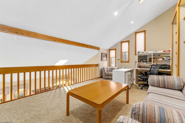 living area featuring light carpet, vaulted ceiling with skylight, and a textured ceiling