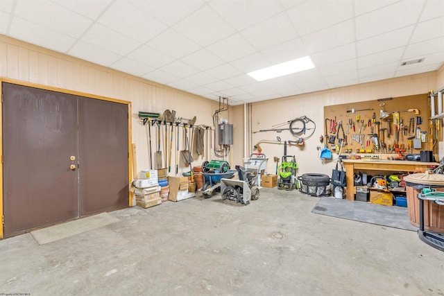 garage featuring a workshop area and visible vents