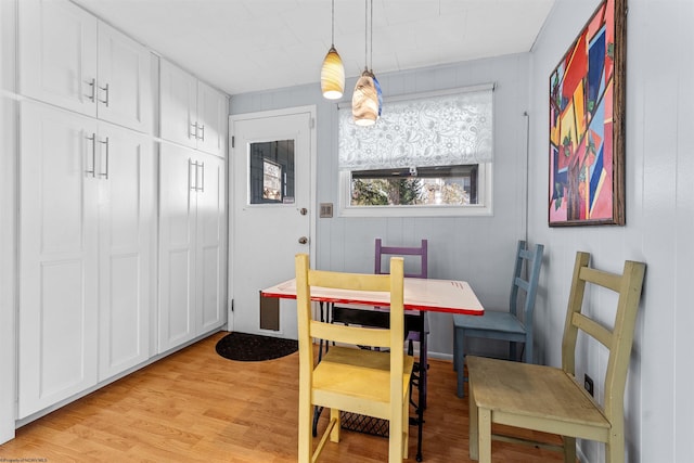 dining space featuring light wood finished floors