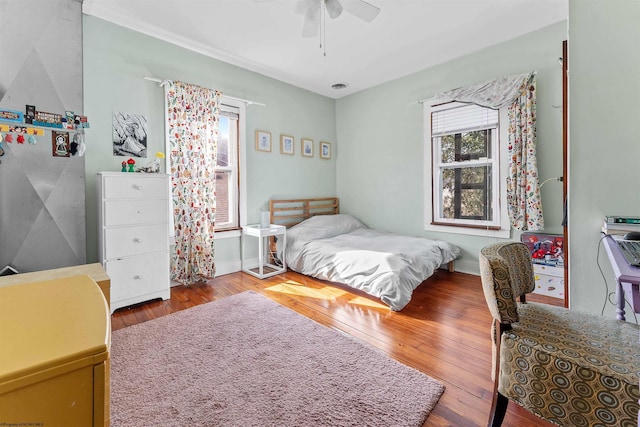 bedroom featuring ceiling fan and hardwood / wood-style flooring