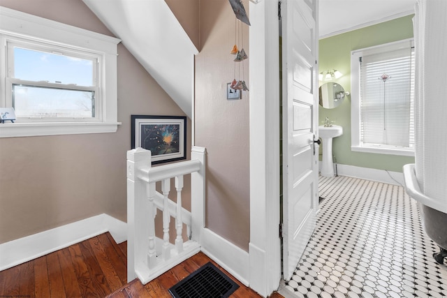 bathroom with lofted ceiling, baseboards, and visible vents