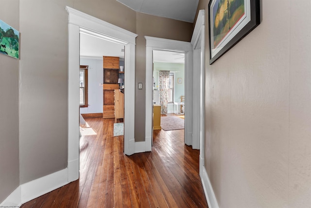 hall featuring dark wood finished floors and baseboards