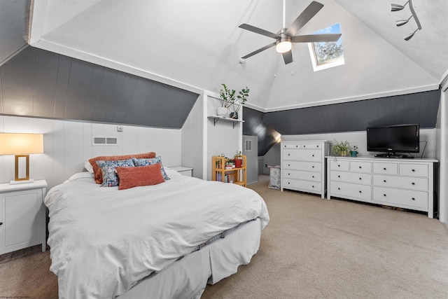 bedroom with carpet floors, vaulted ceiling with skylight, visible vents, and ceiling fan