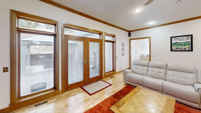 living room with light wood-style flooring, recessed lighting, visible vents, french doors, and crown molding